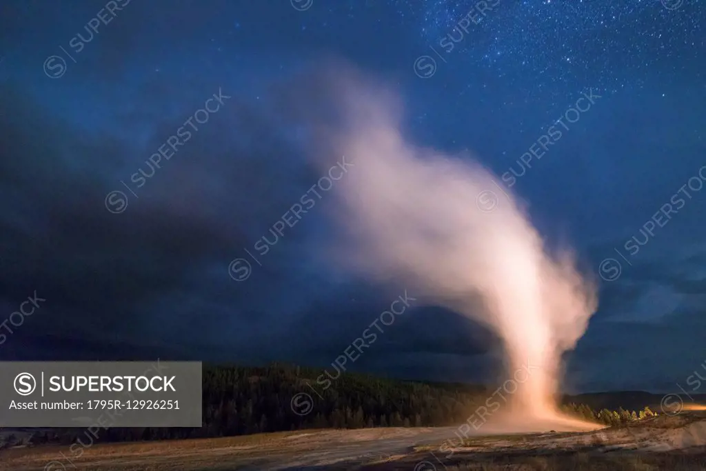 Geyser erupting at night