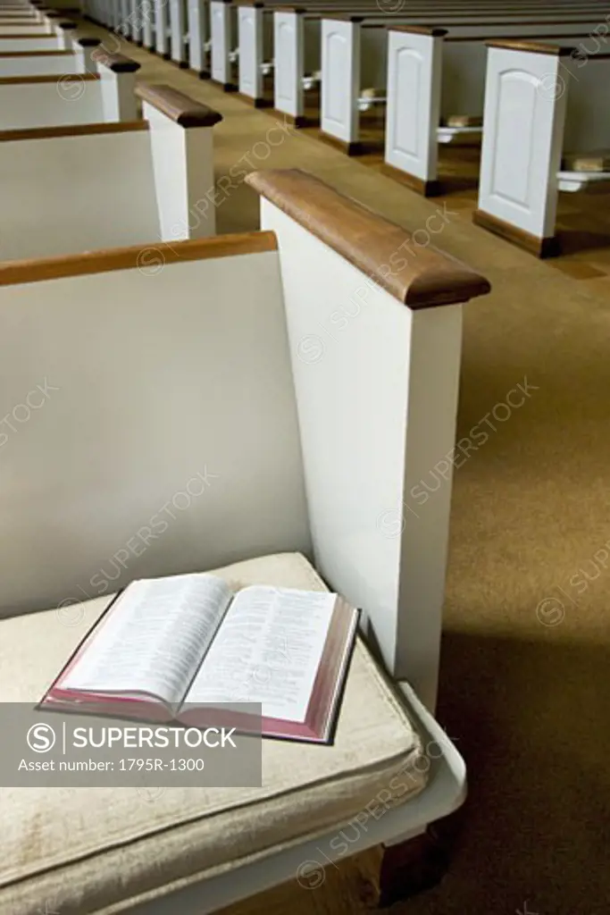 Interior of a church with Bible on a pew