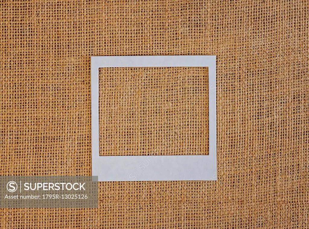 Studio shot of picture frame on fabric