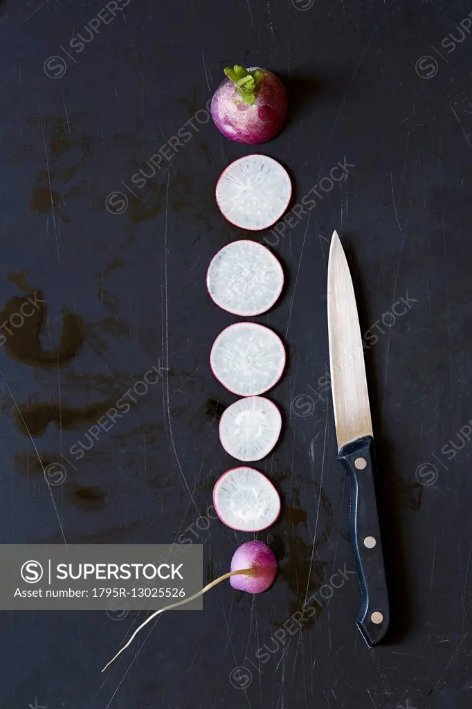 Slices of radish and kitchen knife
