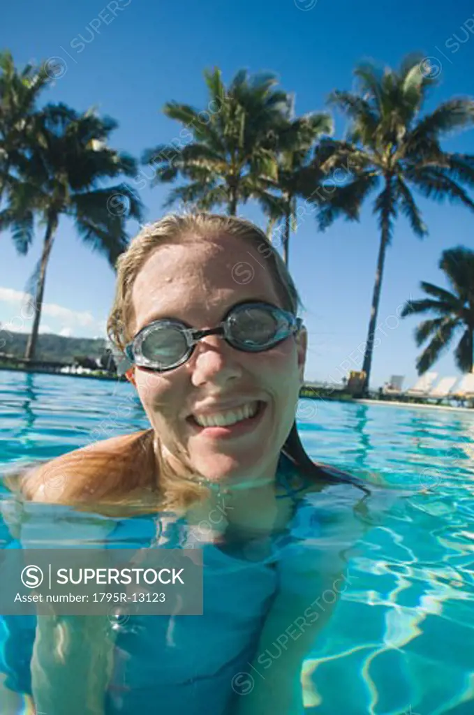 Woman wearing goggles in swimming pool