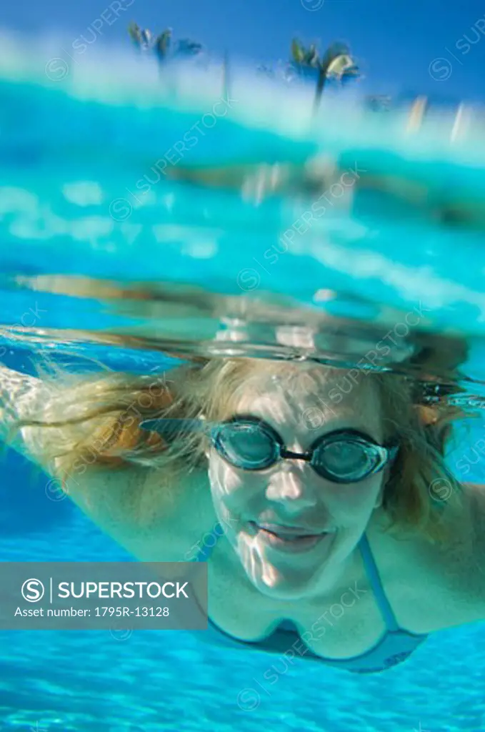 Woman wearing goggles underwater