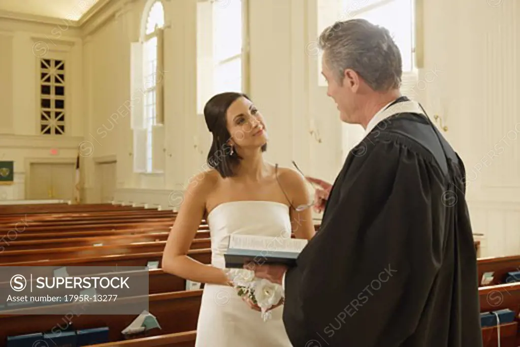 Priest talking to bride