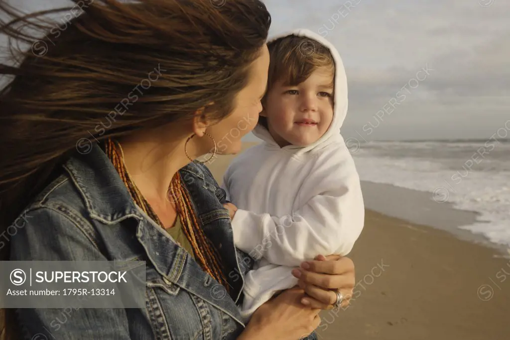 Mother holding baby at beach