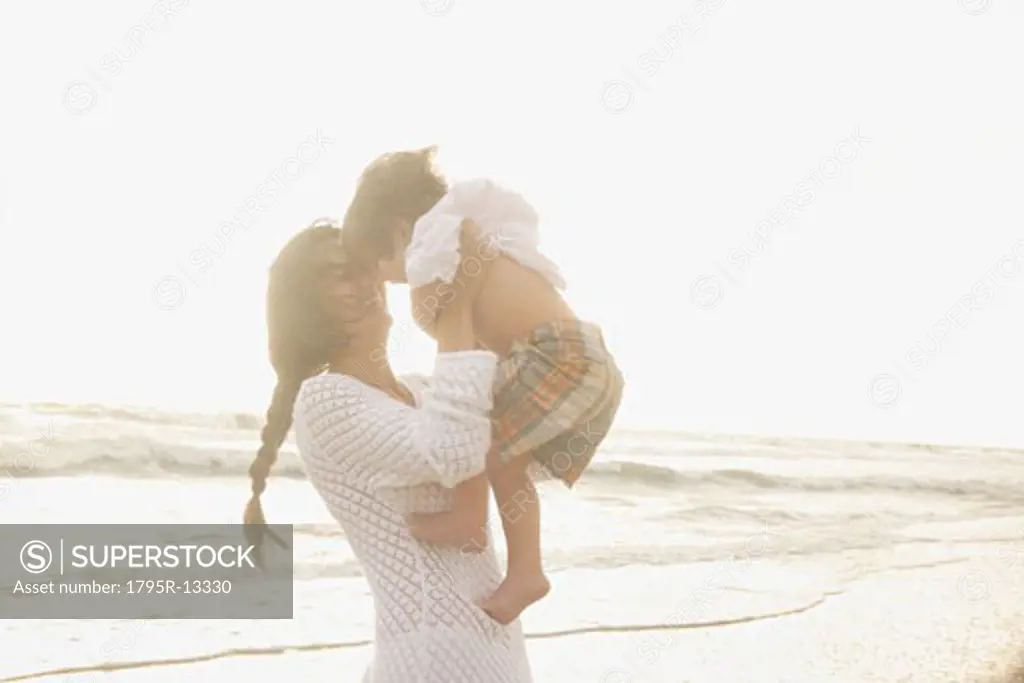 Mother holding son at beach
