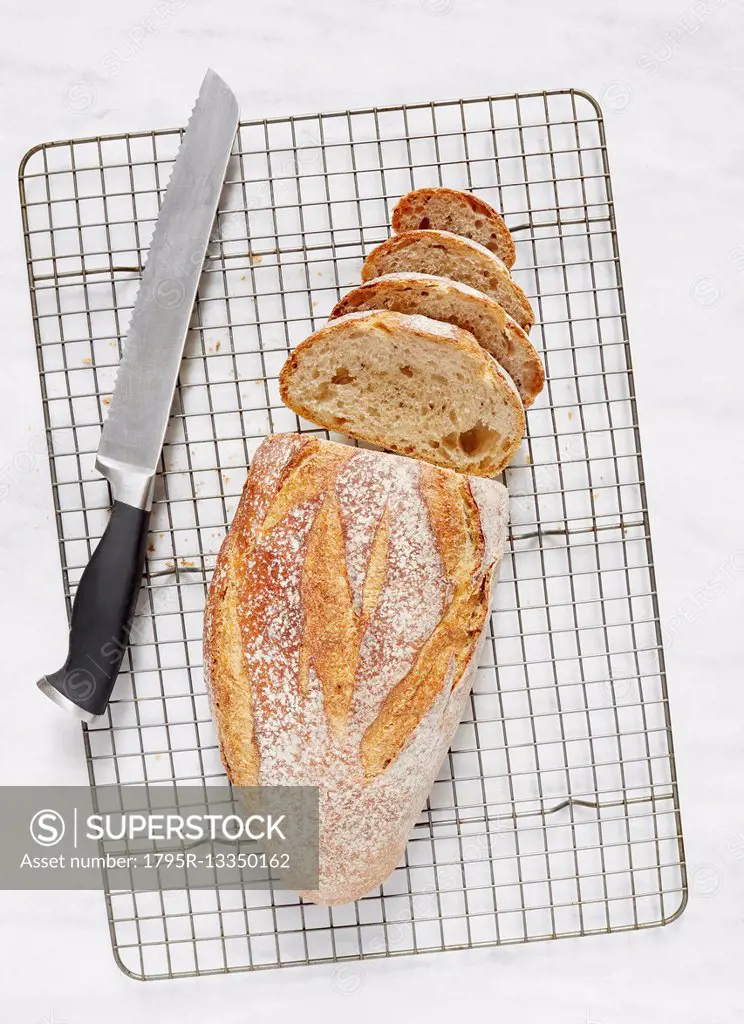 Overhead view of loaf of rye bread and knife