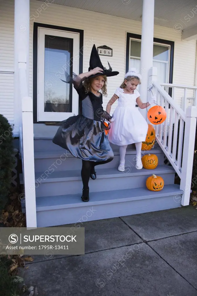Girls dressed in witch and princess Halloween costumes