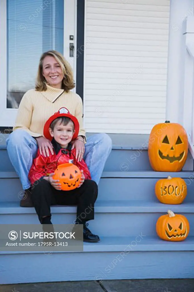 Mother and son dressed in fireman Halloween costume