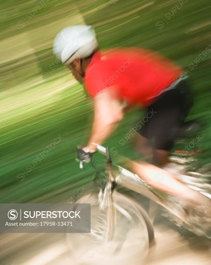 Blurred shot of man riding mountain bike