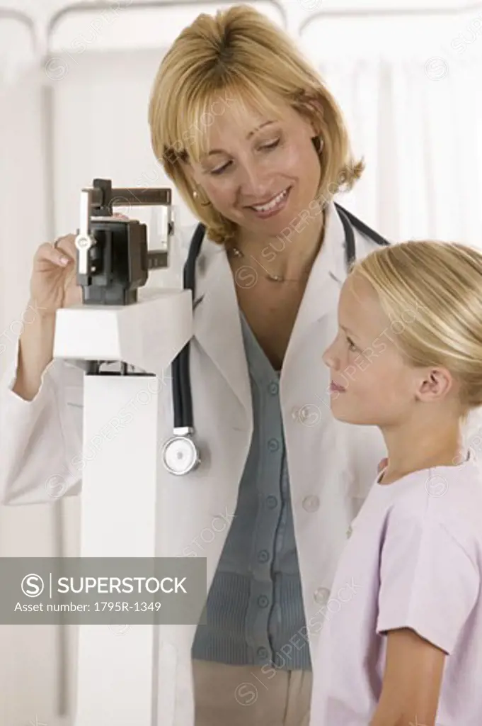 Female doctor with little girl patient