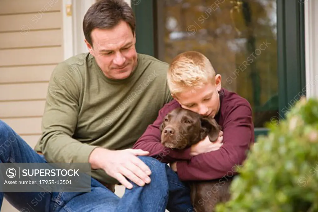 Father and son with dog outdoors