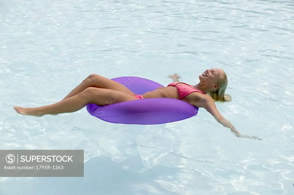 Woman floating in a swimming pool