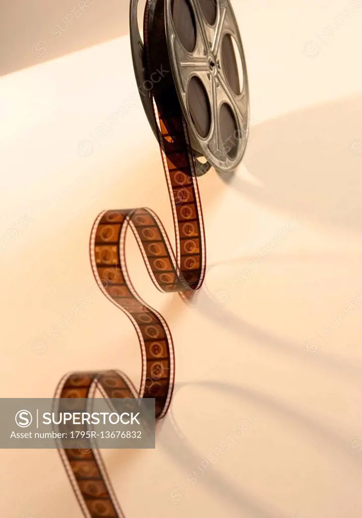 Movie film reel unrolling from above - SuperStock