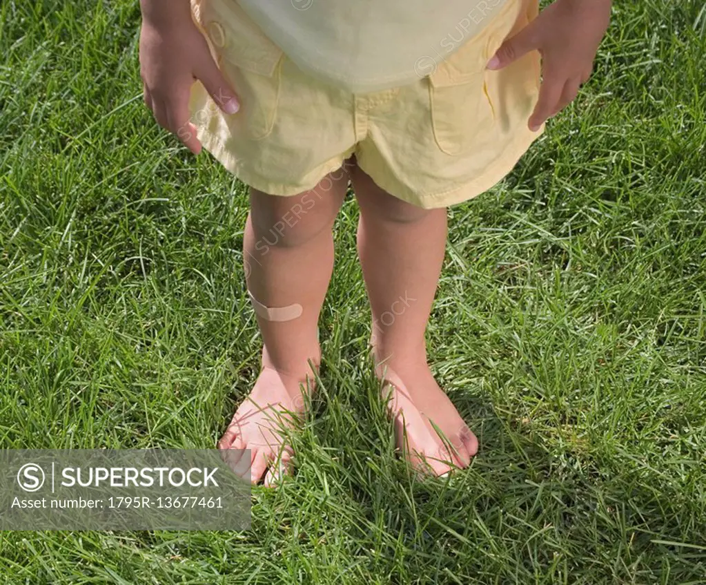 Child standing in bare feet