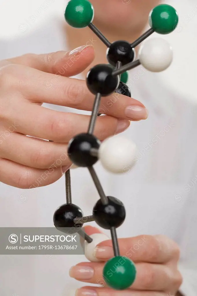 Hands holding molecular model