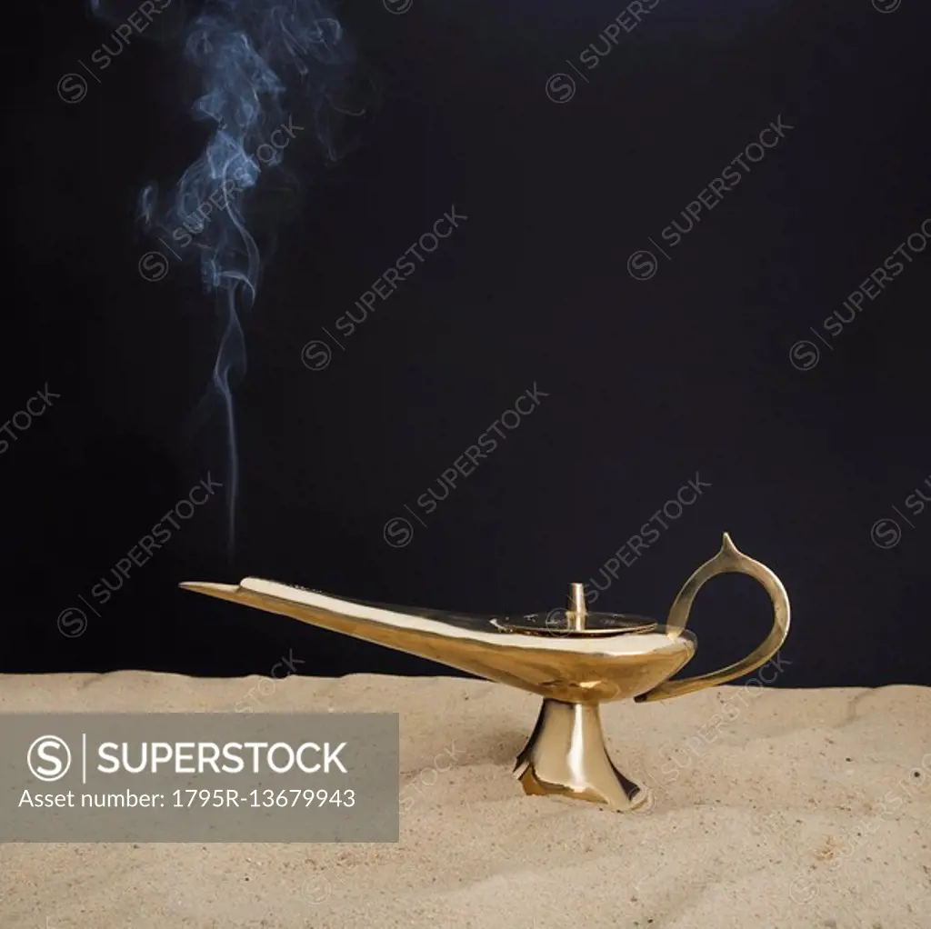 Close up of incense burner on sand