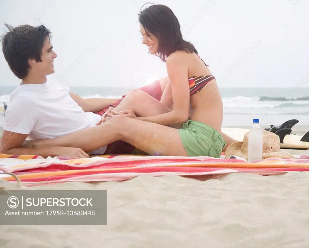 Couple sitting on blanket at beach