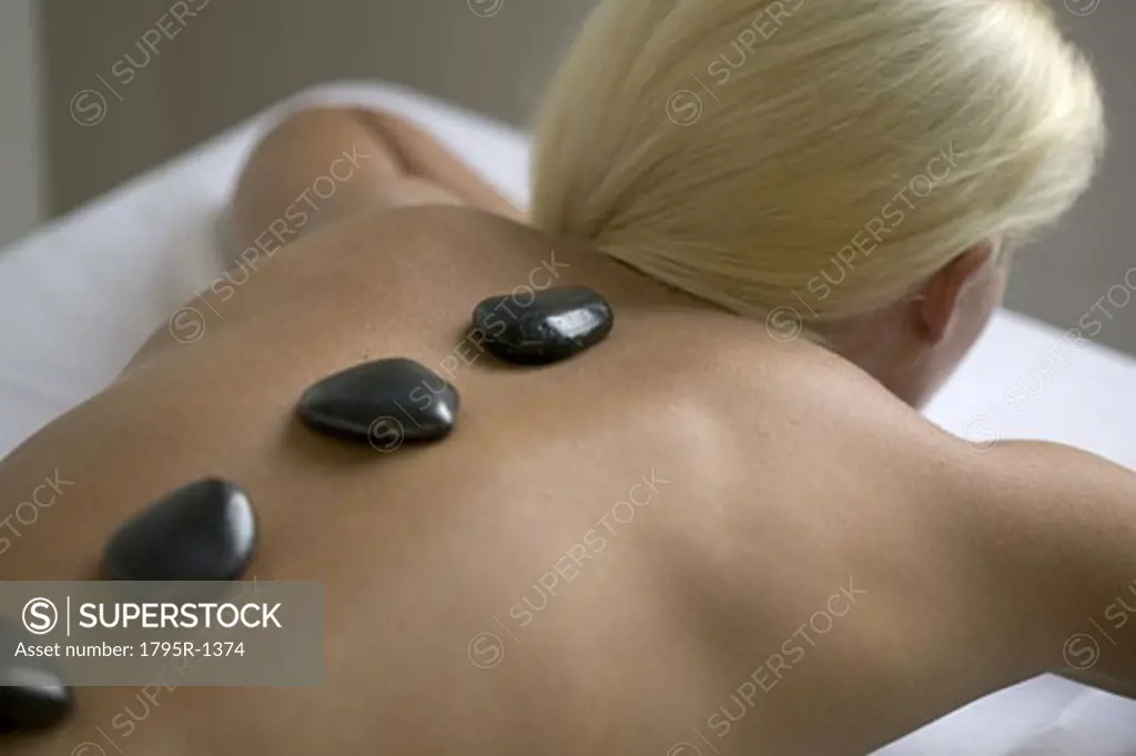 Woman receiving a hot rock treatment