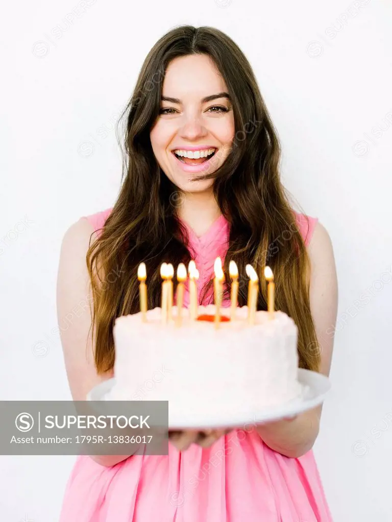 Portrait of woman holding birthday cake