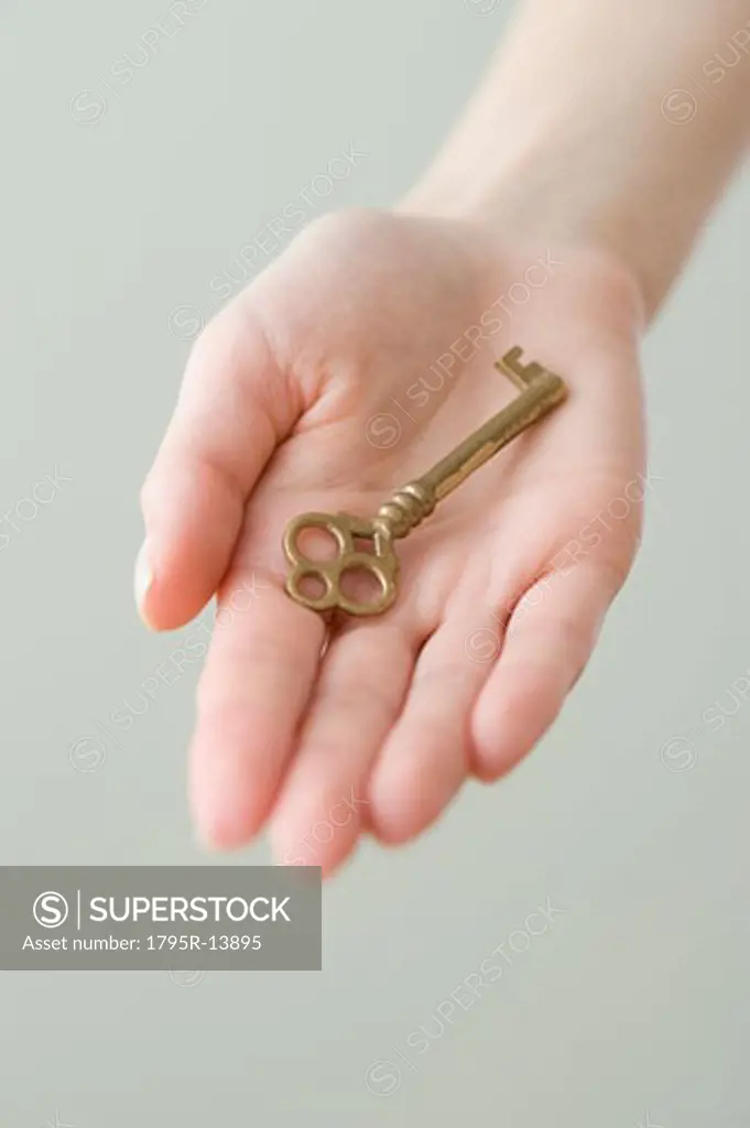 Old fashioned key in woman's hand