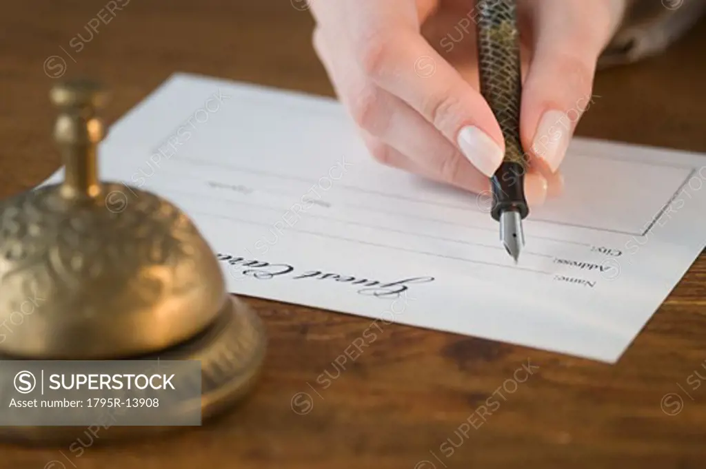 Woman filling out hotel registration