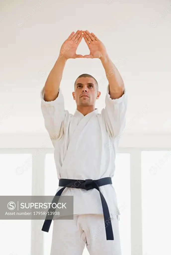 Hispanic male karate black belt in stance