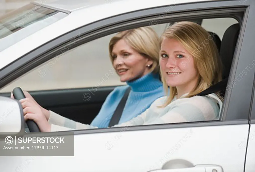Teenaged girl driving with mother