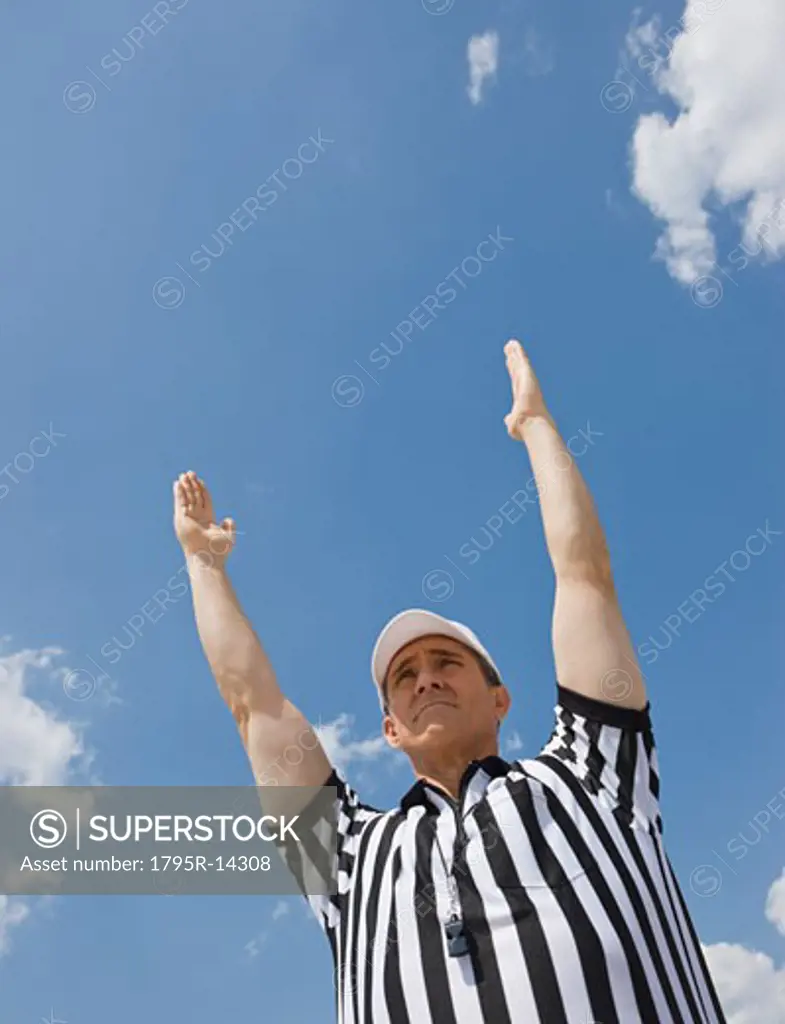 Male football referee making touchdown call