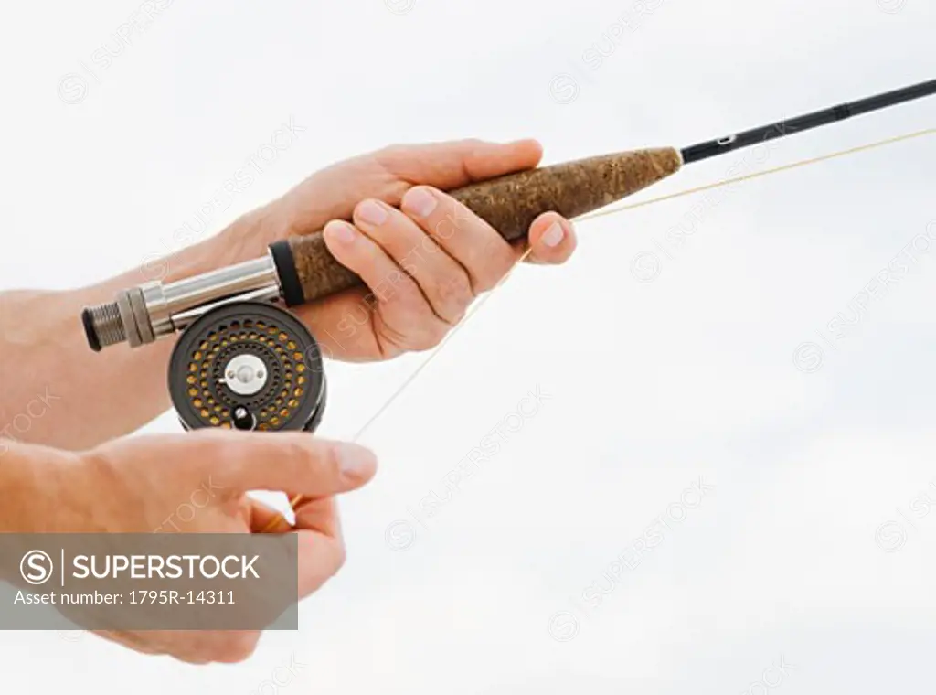 Close-up of man fishing rod