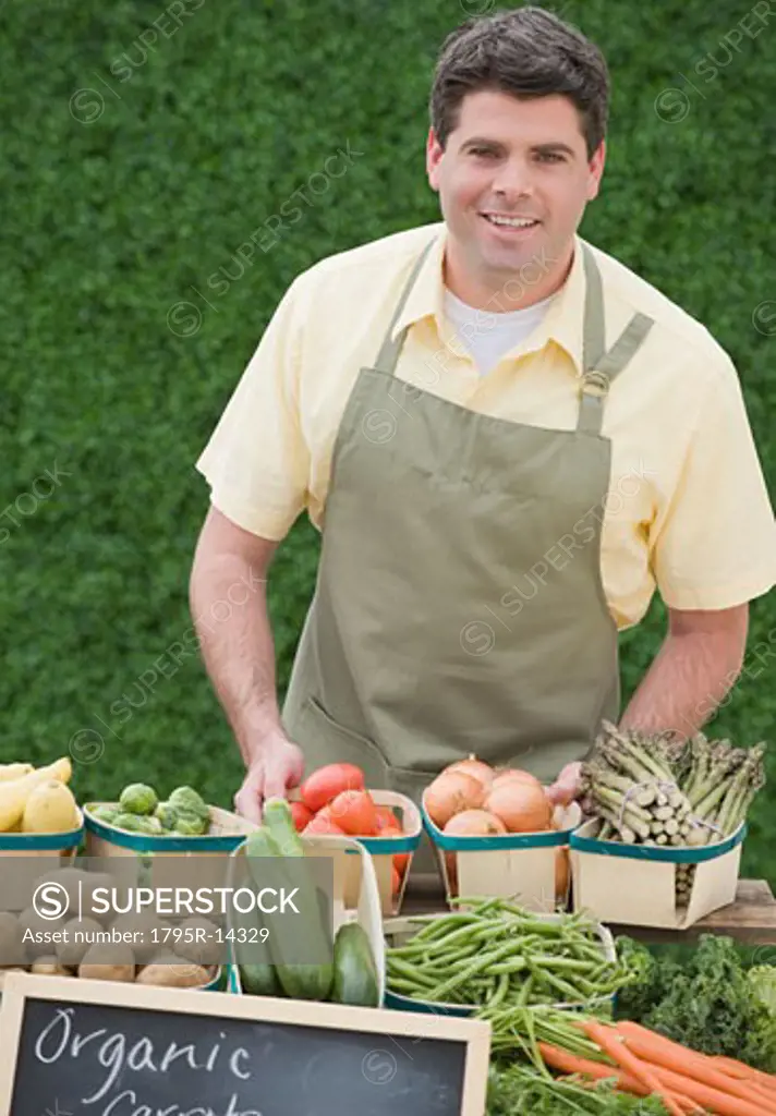 Man next to baskets of vegetables