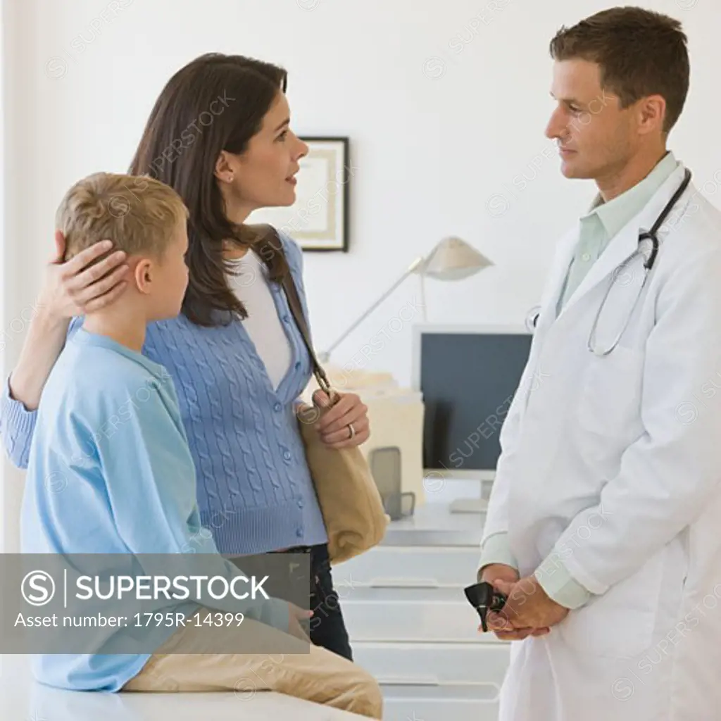 Male doctor talking to mother and son