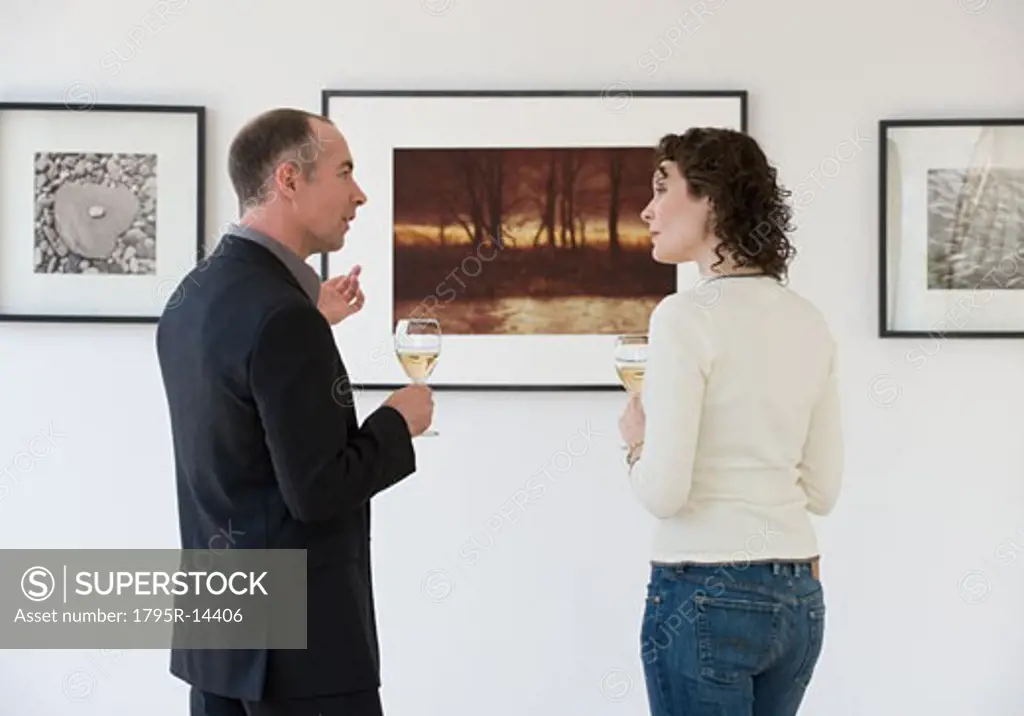 Couple discussing art at art gallery