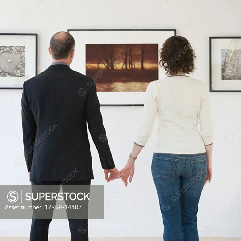 Couple looking at art in art gallery