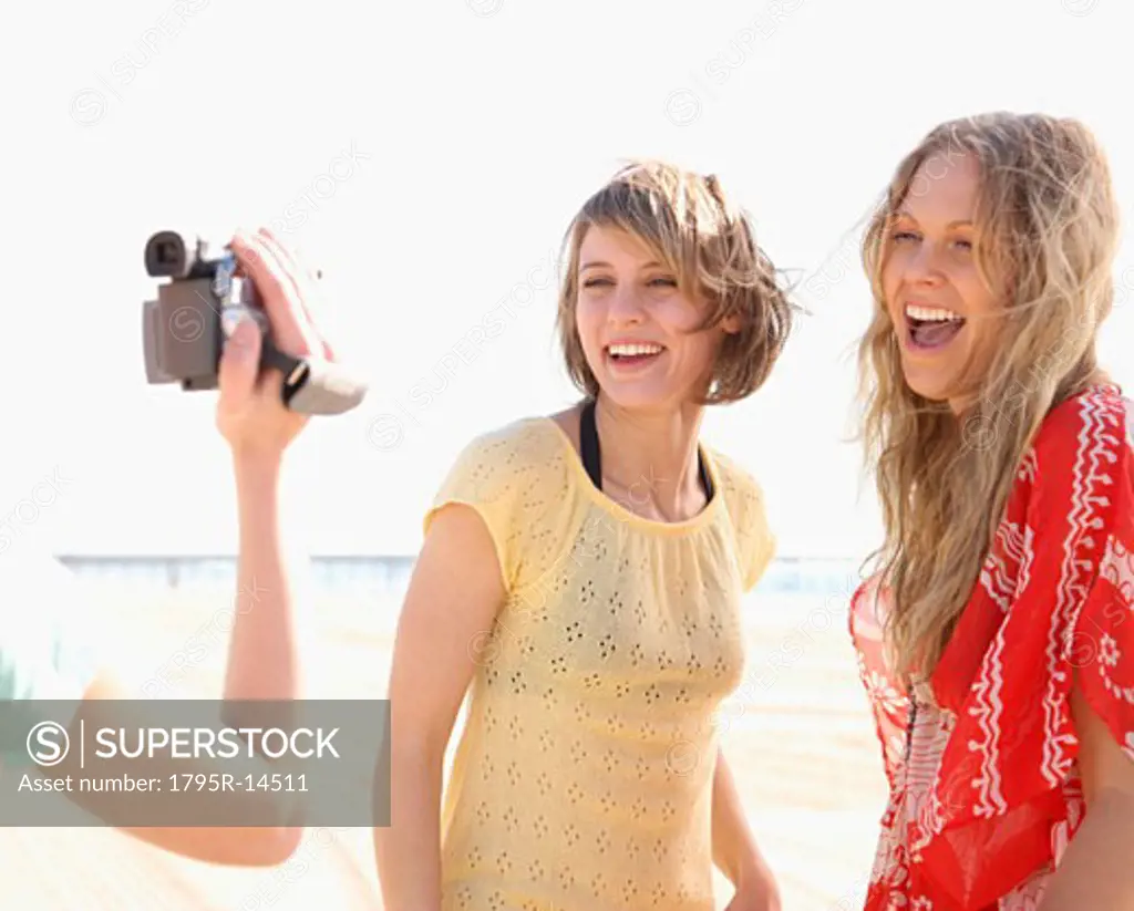 Women being filmed on beach