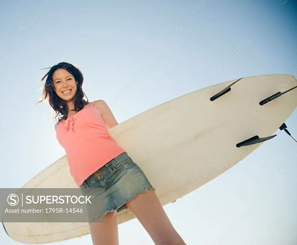 Woman holding surfboard