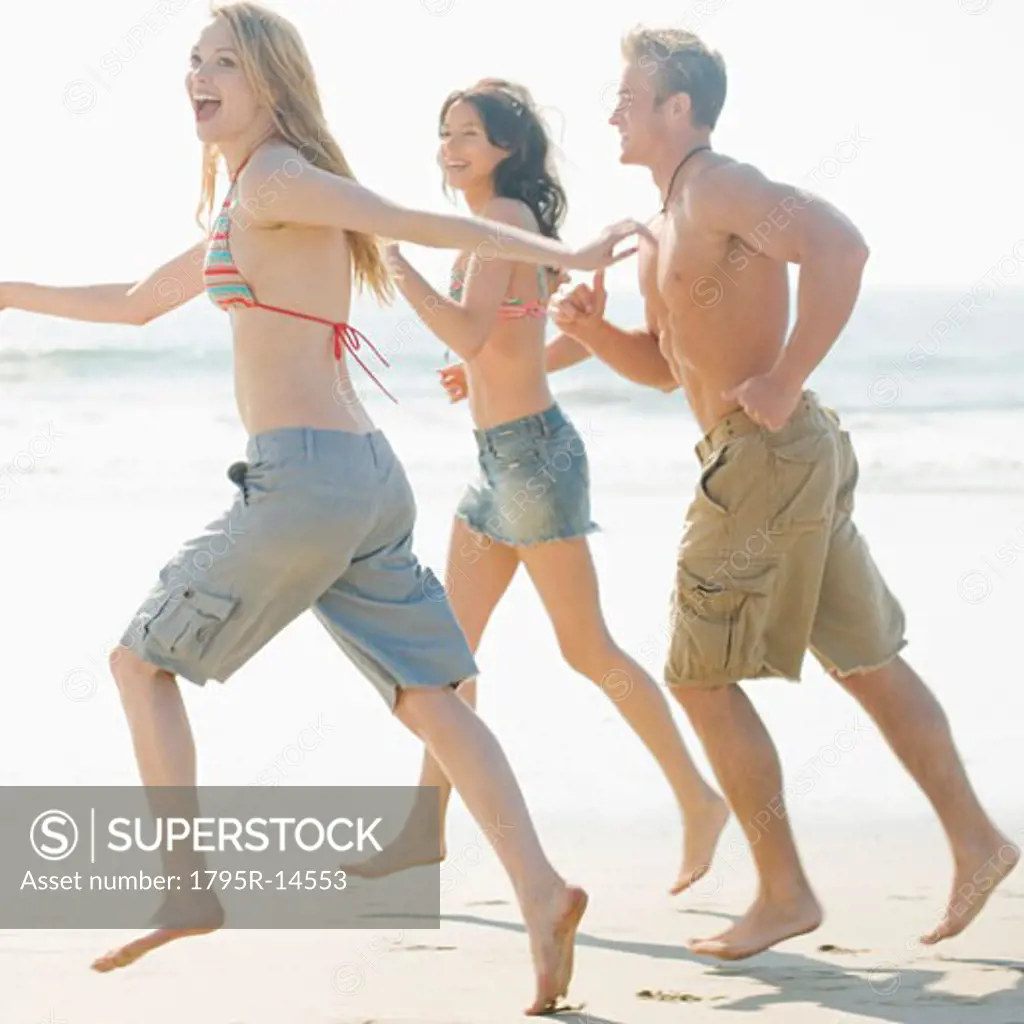 Friends running on beach