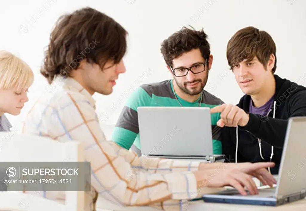 College students with laptops in classroom