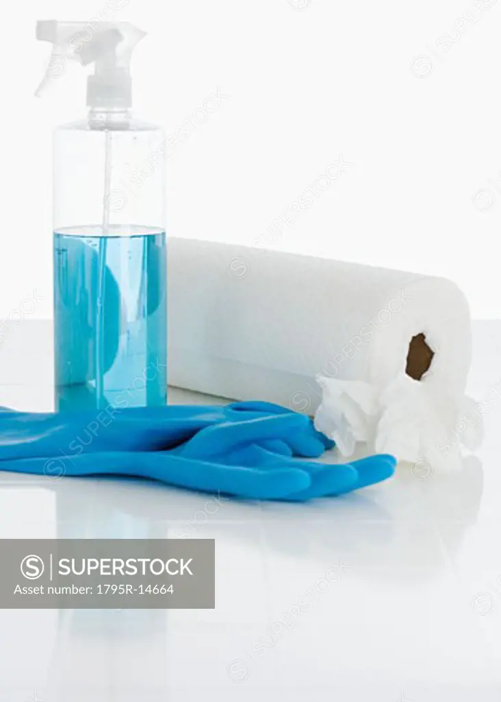 Rubber gloves and cleaning solution next to paper towels
