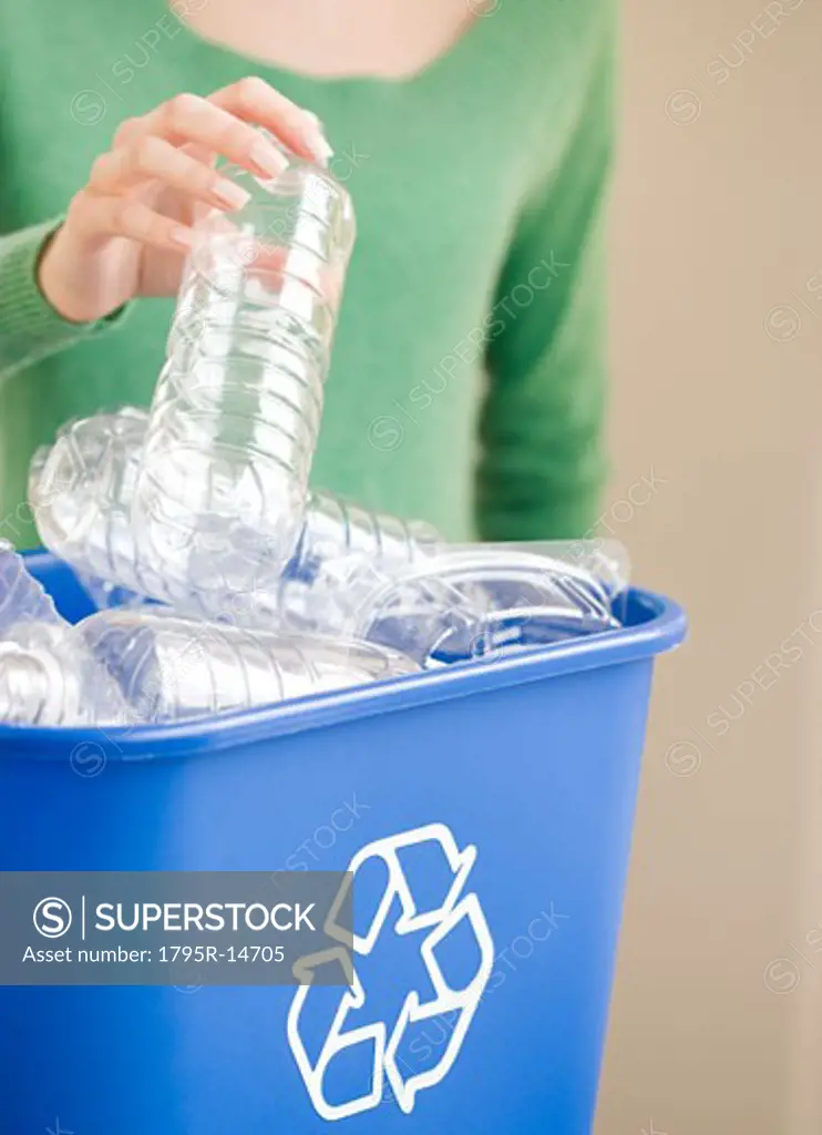 Woman filling recycling bin
