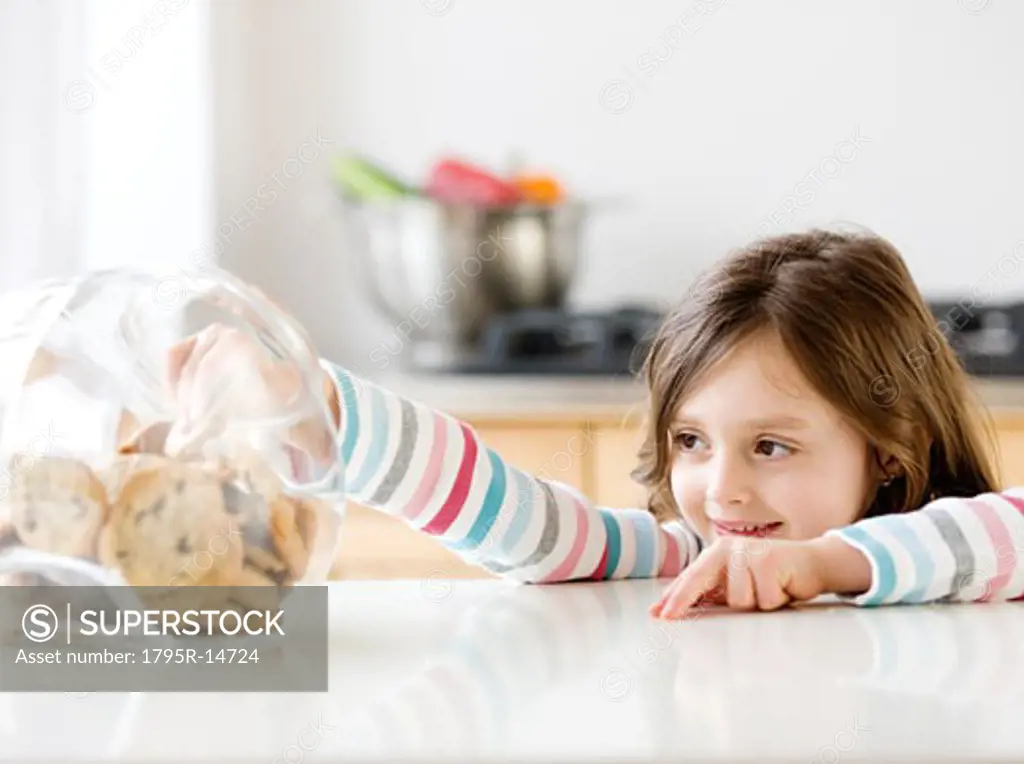 Girl reaching into cookie jar
