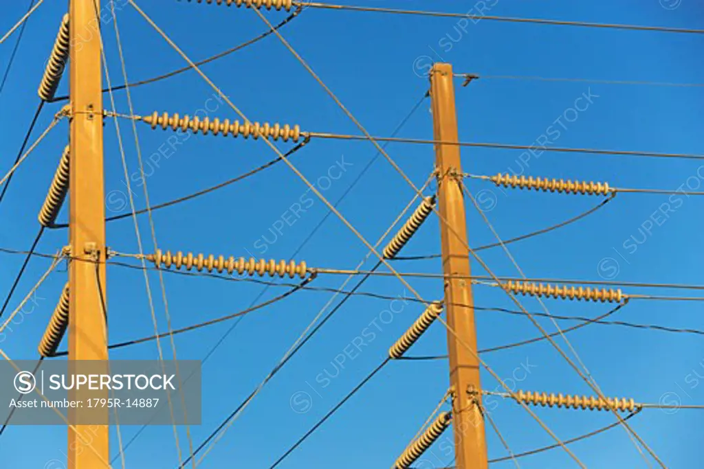 Low angle view of power lines on poles