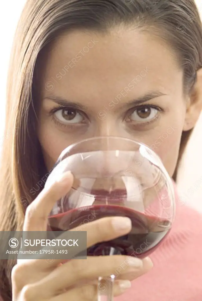 A woman sipping red wine