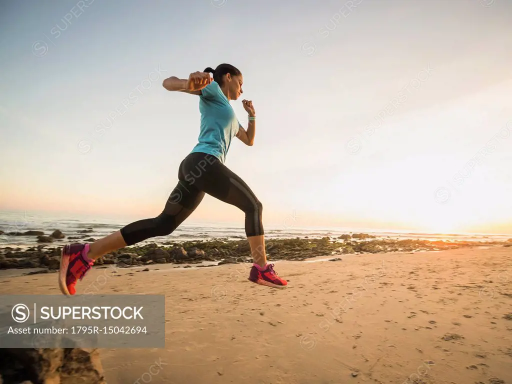 USA, California, Newport Beach, Woman jogging on beach