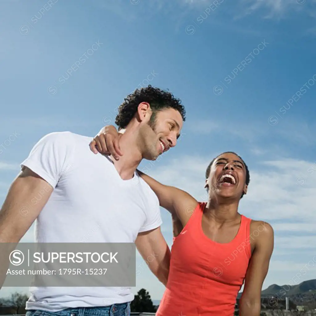 Multi-ethnic couple laughing