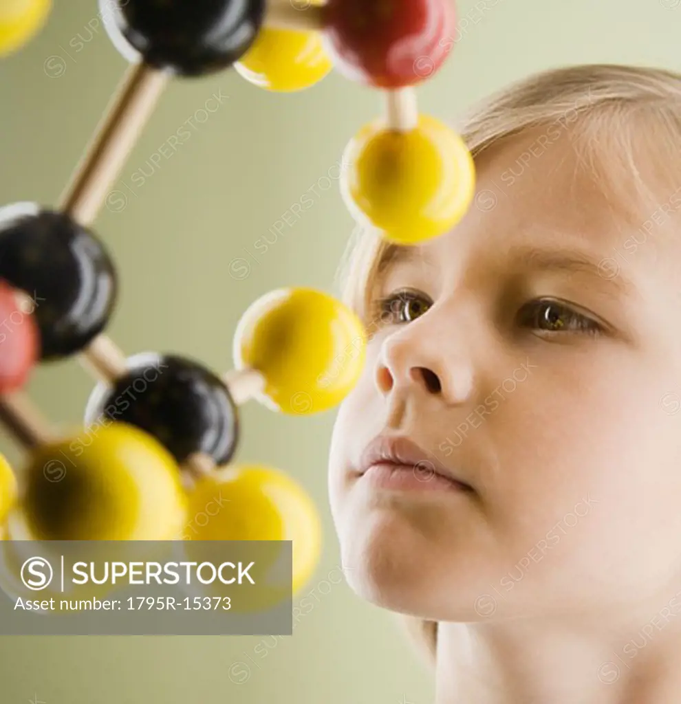 Boy looking at molecular model