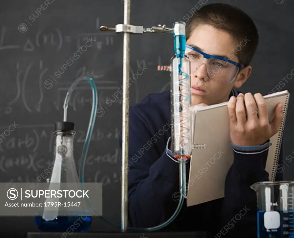 Boy taking notes in science class