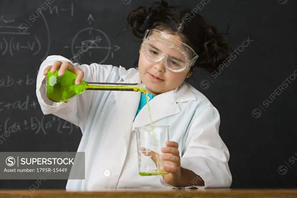 Girl pouring liquid in science class