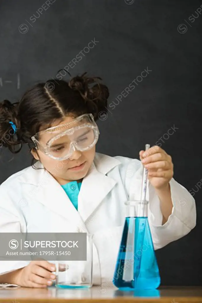 Girl measuring liquid in science class