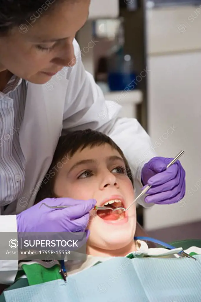 Female dentist examining patient