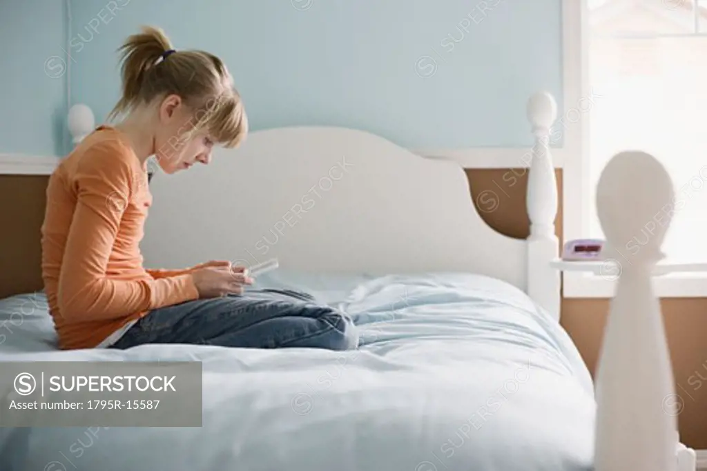 Girl playing handheld video game